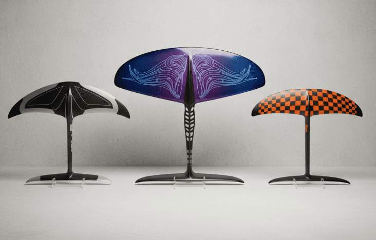 A collection of three custom carbon fiber hydrofoils, each with different designs, showcasing a variety of shapes, sizes, and color schemes. The hydrofoils should be displayed in high detail against a neutral background, highlighting their individual features and customization options.